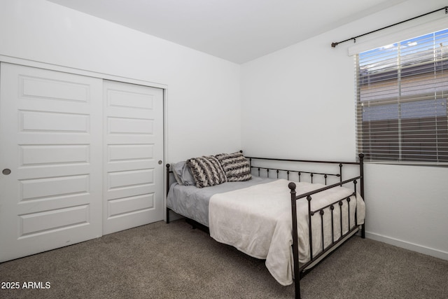 bedroom featuring dark carpet and a closet