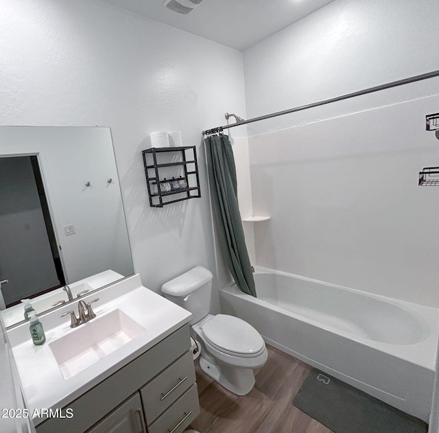 full bathroom with vanity, hardwood / wood-style floors, shower / bath combination with curtain, and toilet