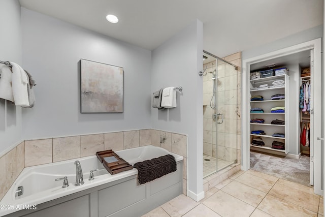 6803 E Main St Unit 5506, Scottsdale, AZ 85251 - bathroom featuring a garden tub, a walk in closet, a stall shower, and tile patterned flooring