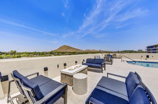 6803 E Main St Unit 5506, Scottsdale, AZ 85251 - view of patio with an outdoor living space with a fire pit and a mountain view