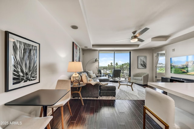 6803 E Main St Unit 5506, Scottsdale, AZ 85251 - living area with a raised ceiling, ceiling fan, dark wood-type flooring, and a wall of windows