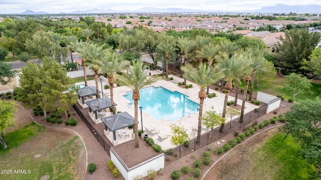 1162 S Agnes Ln, Gilbert, AZ 85296 - aerial view of property's location featuring a pool area, nearby suburban area, and a mountainous background