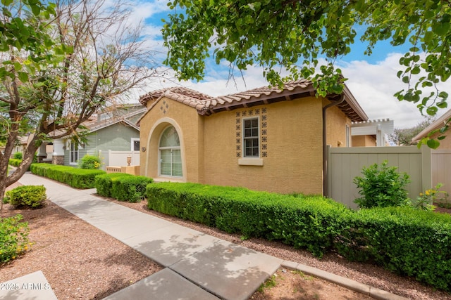 1162 S Agnes Ln, Gilbert, AZ 85296 - view of front facade with stucco siding, fence, and a tile roof