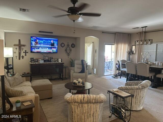 carpeted living room featuring ceiling fan