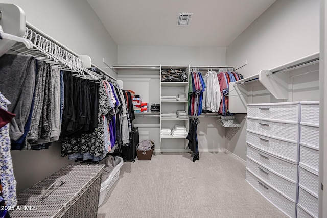 walk in closet with visible vents and carpet flooring