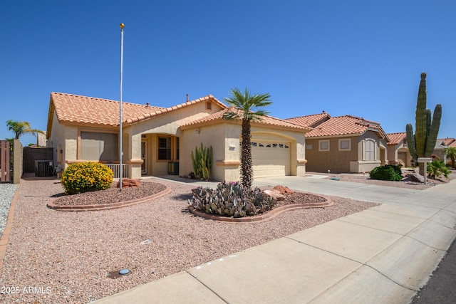 17640 W Babbitt Dr, Surprise, AZ 85374 - mediterranean / spanish-style home with stucco siding, a tiled roof, a gate, concrete driveway, and an attached garage