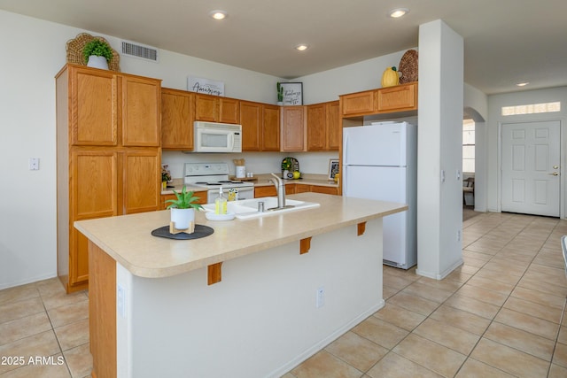 17640 W Babbitt Dr, Surprise, AZ 85374 - kitchen featuring recessed lighting, white appliances, light tile patterned floors, light countertops, and visible vents