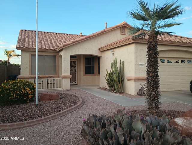 17640 W Babbitt Dr, Surprise, AZ 85374 - mediterranean / spanish-style house featuring stucco siding, a tiled roof, a porch, and a garage