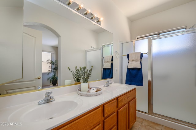 17640 W Babbitt Dr, Surprise, AZ 85374 - bathroom with double vanity, tile patterned floors, a stall shower, and a sink