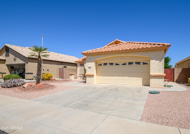 17640 W Babbitt Dr, Surprise, AZ 85374 - mediterranean / spanish-style home featuring stucco siding, fence, concrete driveway, and a tiled roof