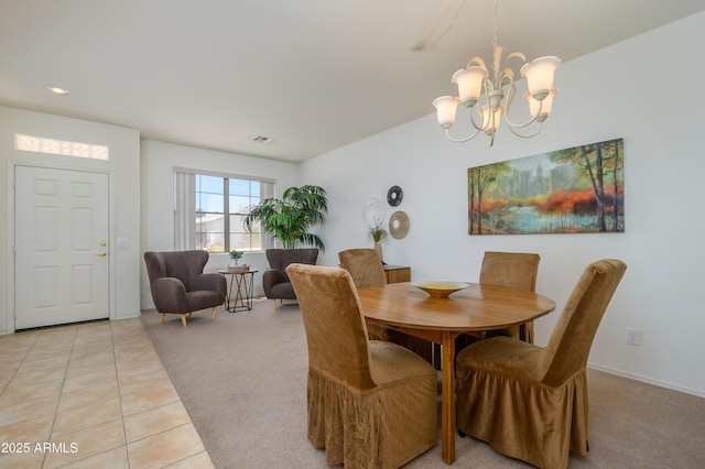 17640 W Babbitt Dr, Surprise, AZ 85374 - dining room with an inviting chandelier, light tile patterned flooring, visible vents, baseboards, and light colored carpet