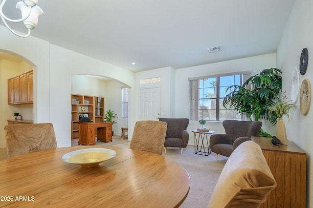 17640 W Babbitt Dr, Surprise, AZ 85374 - dining area with recessed lighting, arched walkways, visible vents, and light colored carpet