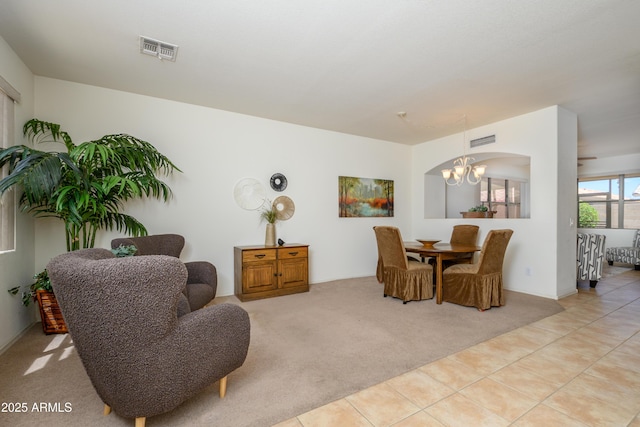 17640 W Babbitt Dr, Surprise, AZ 85374 - dining area with light tile patterned floors, an inviting chandelier, visible vents, and light carpet