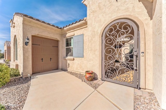 view of exterior entry with a garage