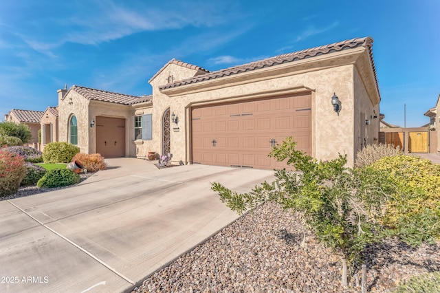 mediterranean / spanish-style home with a garage