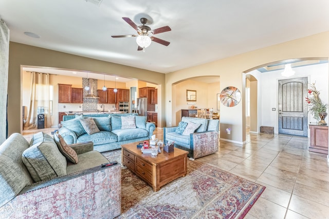 tiled living room with ceiling fan