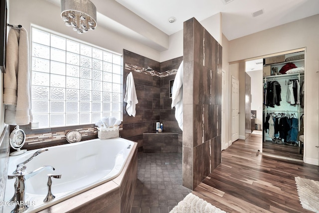 bathroom featuring separate shower and tub and hardwood / wood-style floors