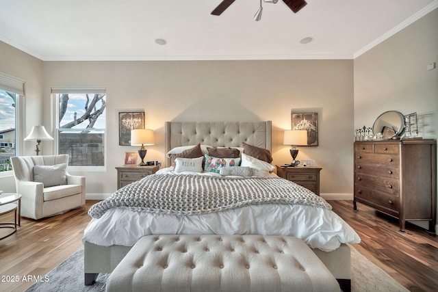 bedroom featuring hardwood / wood-style flooring, ornamental molding, and ceiling fan