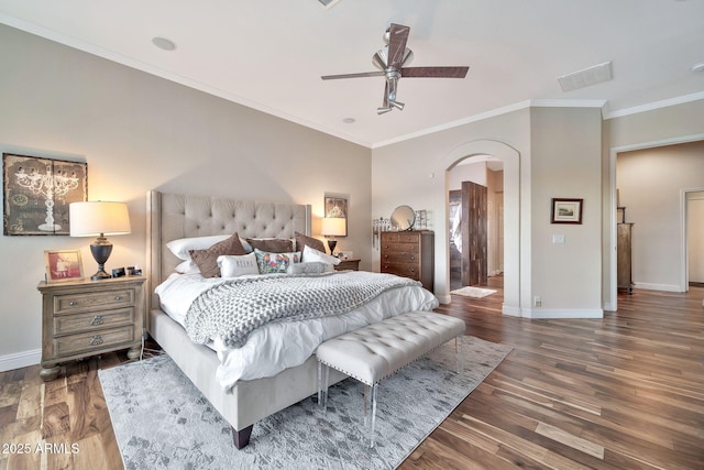 bedroom featuring ceiling fan, ornamental molding, and dark hardwood / wood-style floors