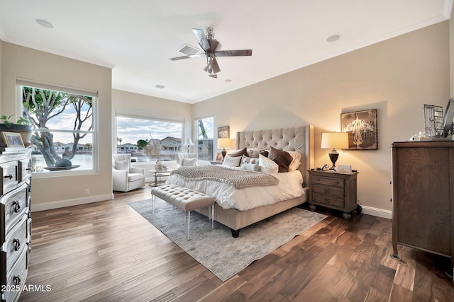 bedroom with dark wood-type flooring, ornamental molding, and ceiling fan