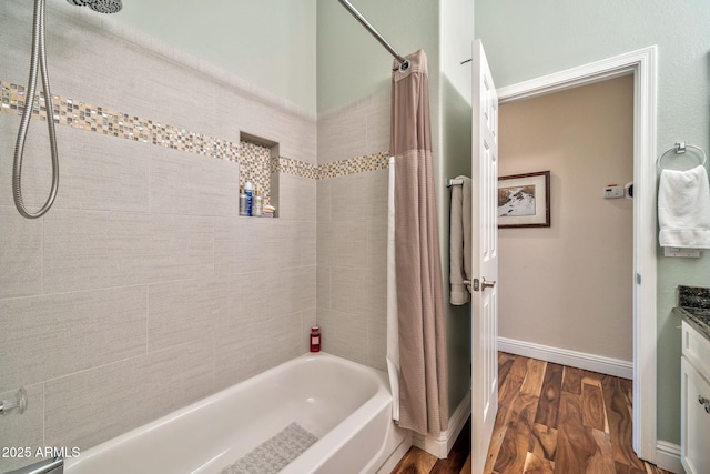 bathroom with vanity, hardwood / wood-style floors, and shower / bath combination with curtain