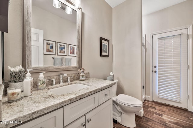 bathroom featuring vanity, toilet, and wood-type flooring