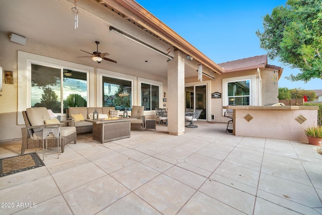 view of patio / terrace with outdoor lounge area, ceiling fan, and a bar