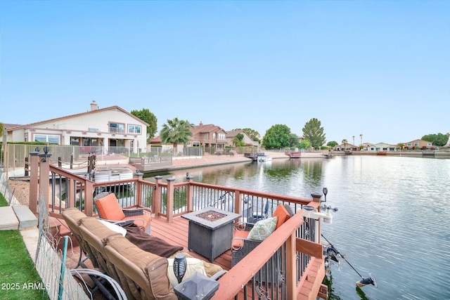 dock area featuring a water view and an outdoor fire pit