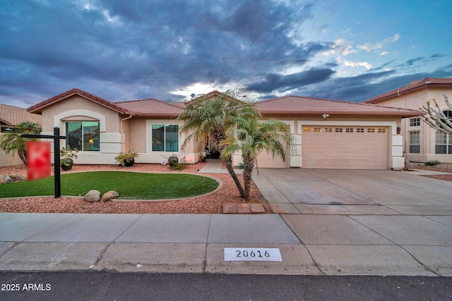 view of front facade with a garage and a front lawn