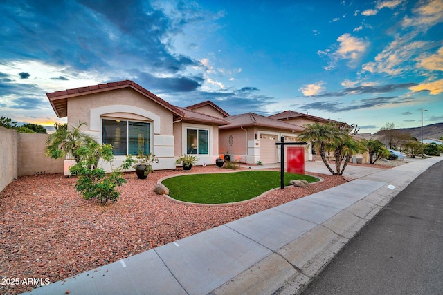 view of front of property with a garage and a front lawn