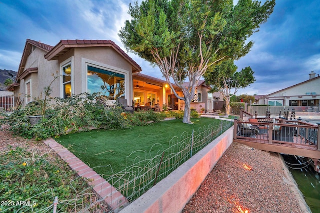 view of property exterior with a wooden deck and a yard