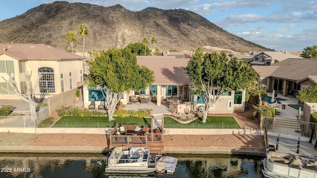 rear view of property with a water and mountain view