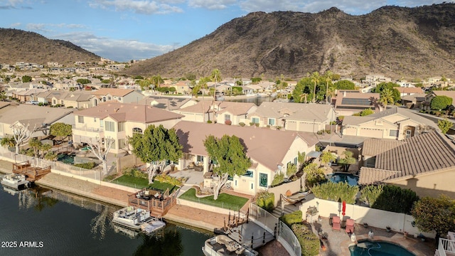 birds eye view of property with a water and mountain view