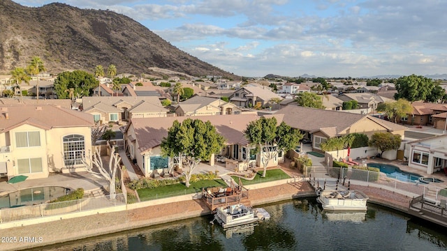 drone / aerial view with a water and mountain view