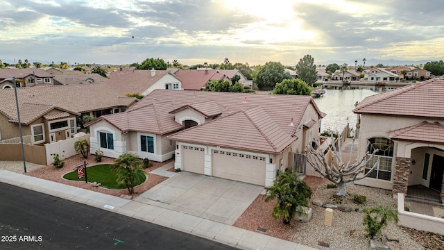 view of front facade featuring a garage and a water view