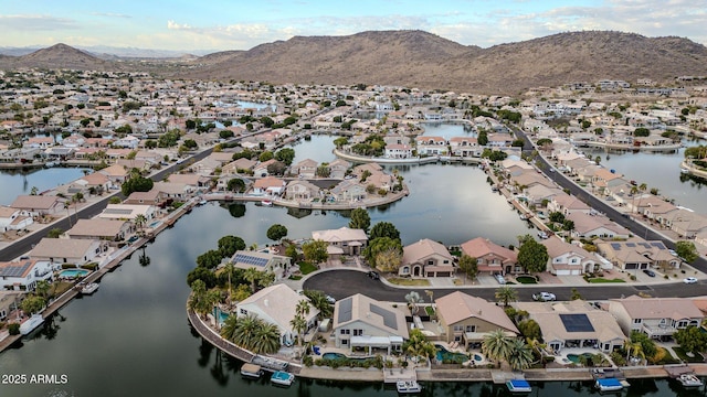 aerial view featuring a water and mountain view