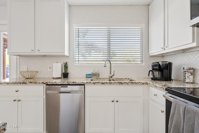 kitchen with appliances with stainless steel finishes, sink, and white cabinets