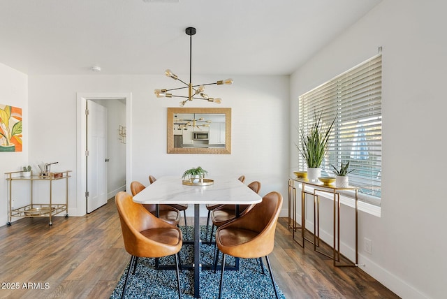 dining area with an inviting chandelier and dark wood-type flooring