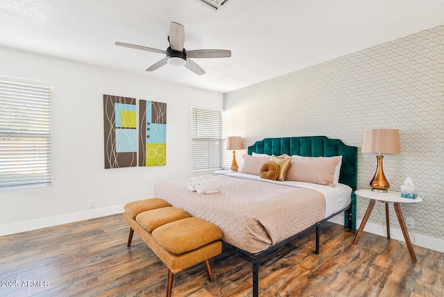 bedroom with ceiling fan and dark hardwood / wood-style floors