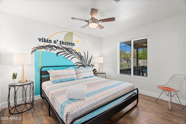 bedroom with dark hardwood / wood-style floors and ceiling fan