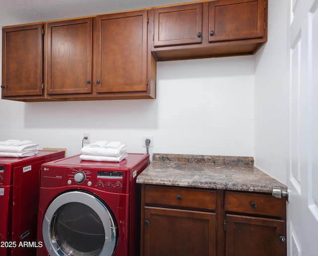 washroom featuring cabinets and separate washer and dryer