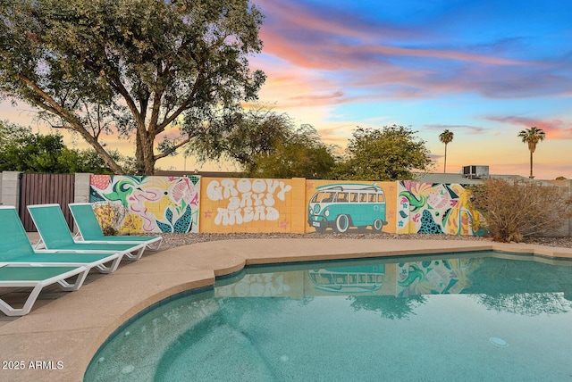 view of pool at dusk