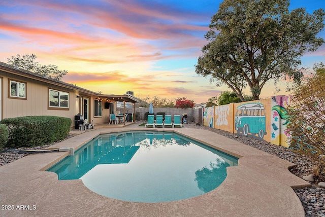 pool at dusk with a patio