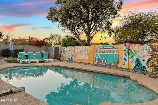 pool at dusk with a patio