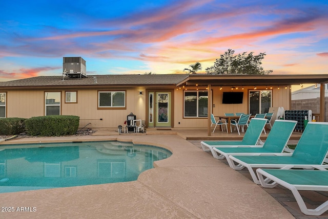 back of property with a patio and central AC