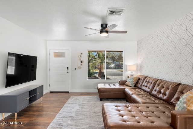 living room with dark hardwood / wood-style flooring and ceiling fan