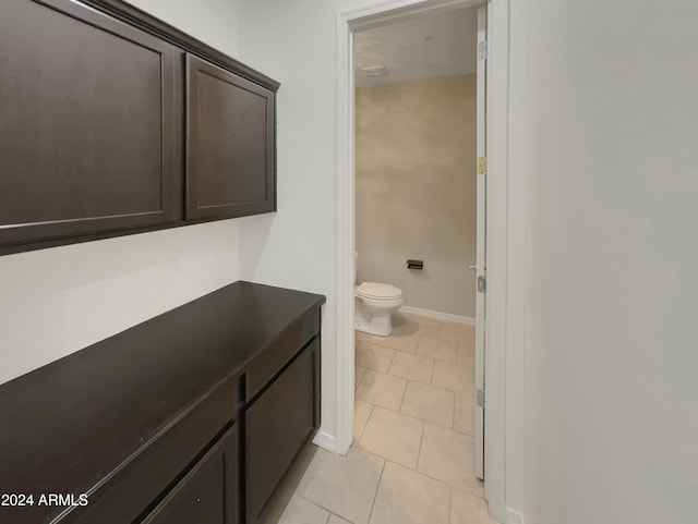 bathroom featuring tile patterned flooring and toilet