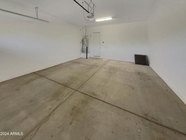 garage featuring strapped water heater and a garage door opener