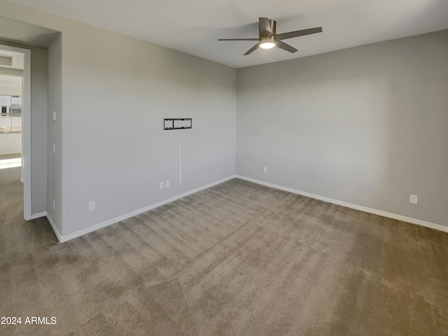 carpeted empty room featuring ceiling fan