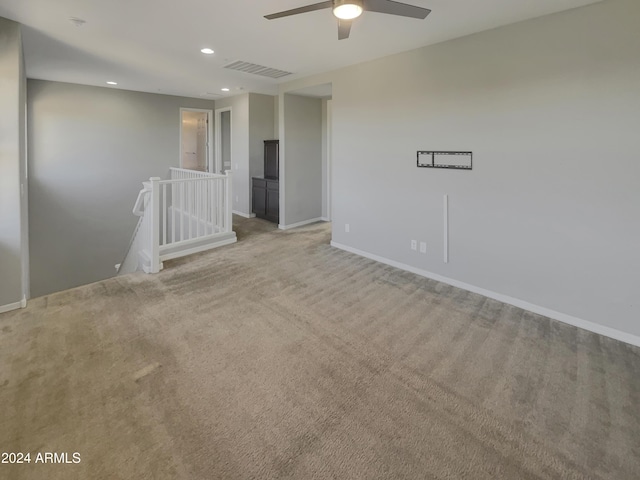 empty room featuring light carpet and ceiling fan